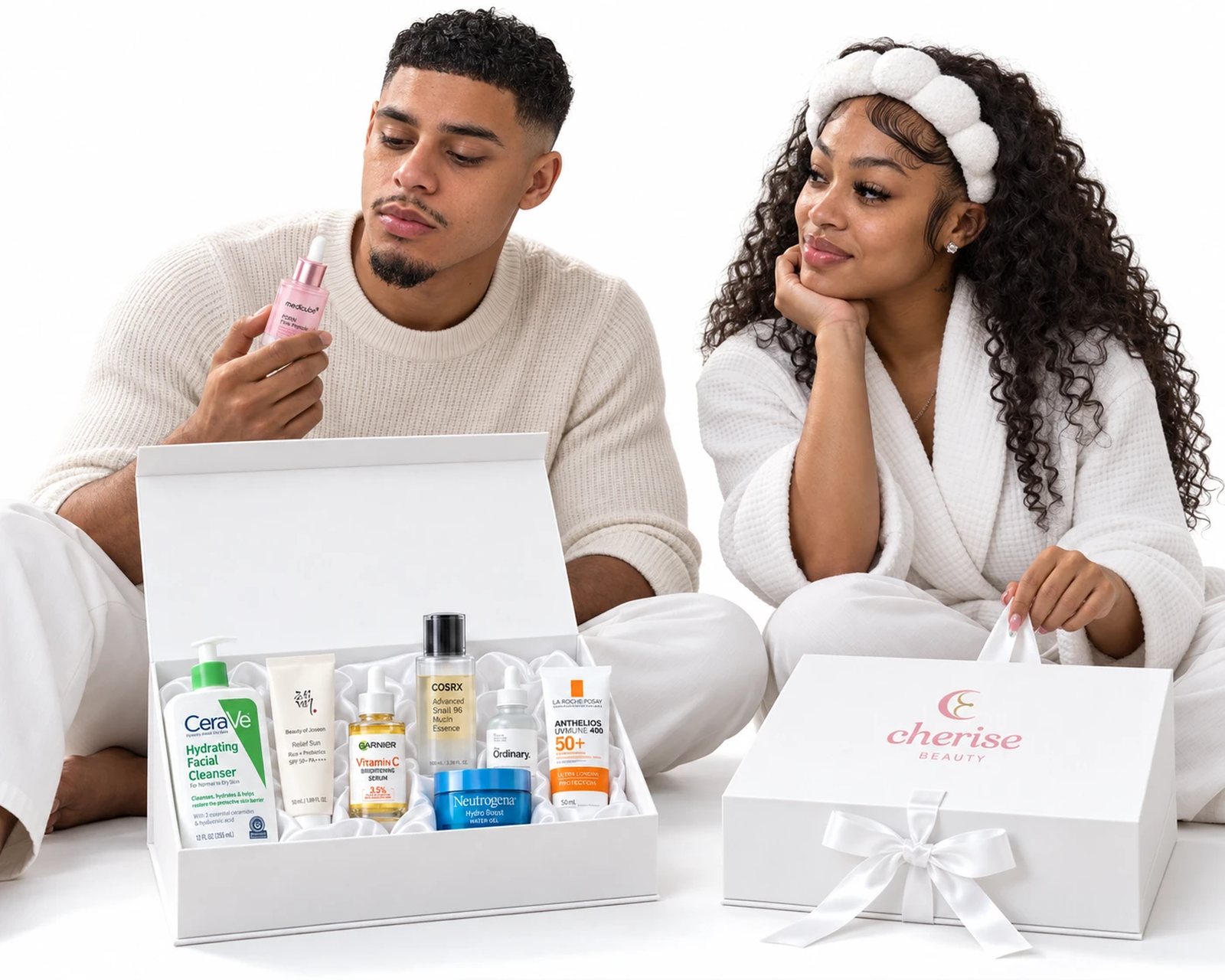 A man and a woman beside their Cherise boxes, one open on the routine chosen for their own skin