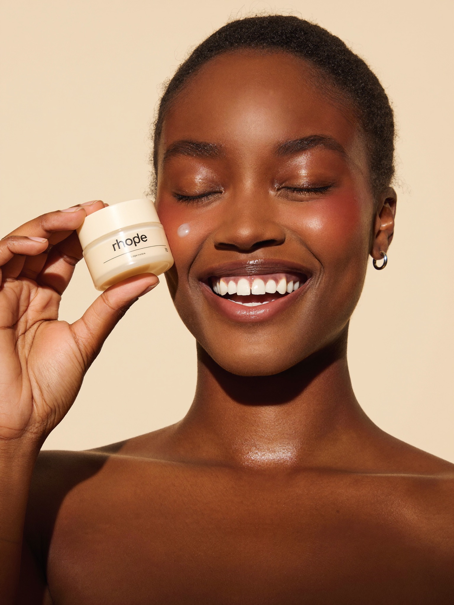 Woman holding a hydrating cream jar