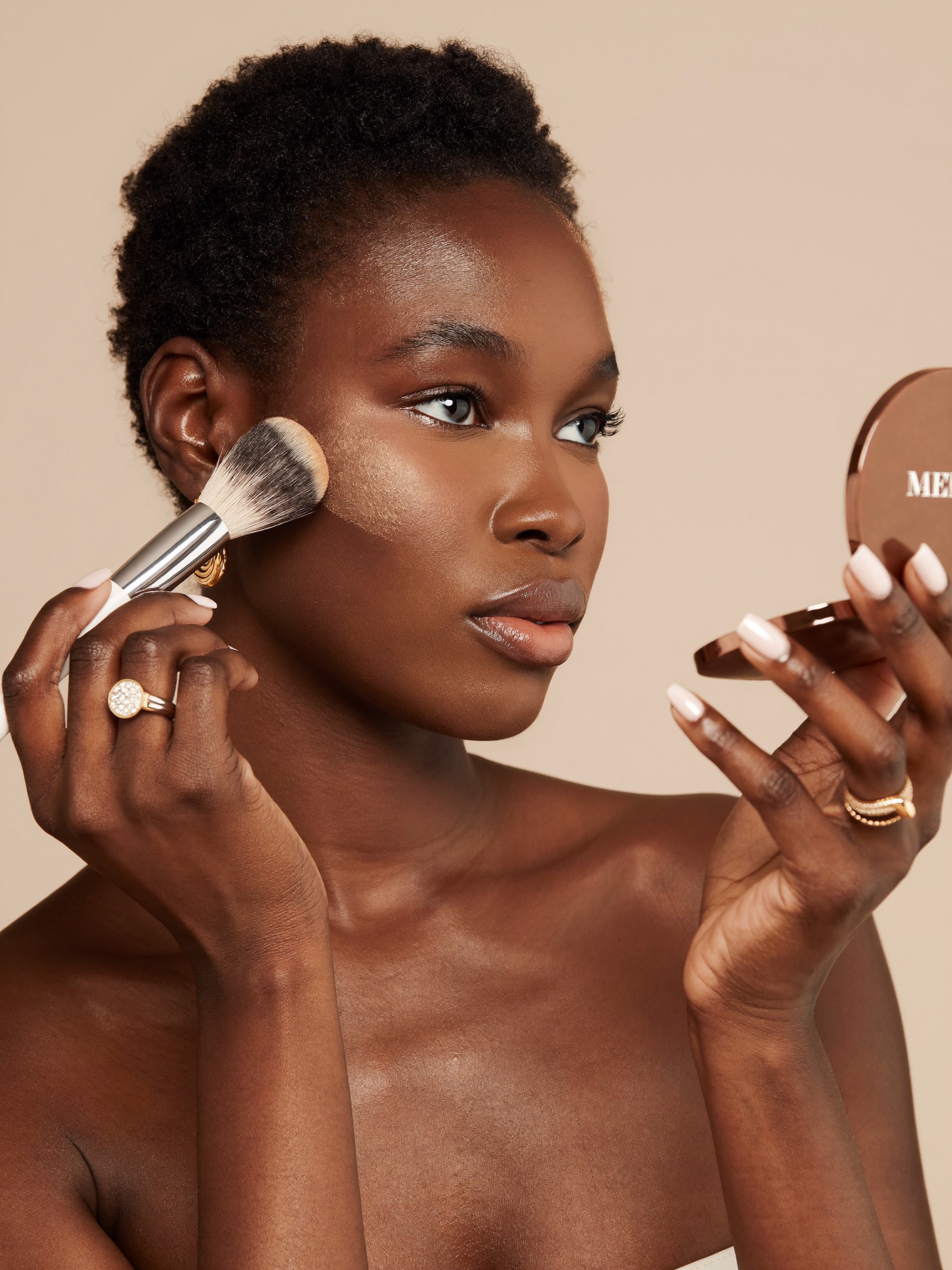 Woman applying powder with a brush