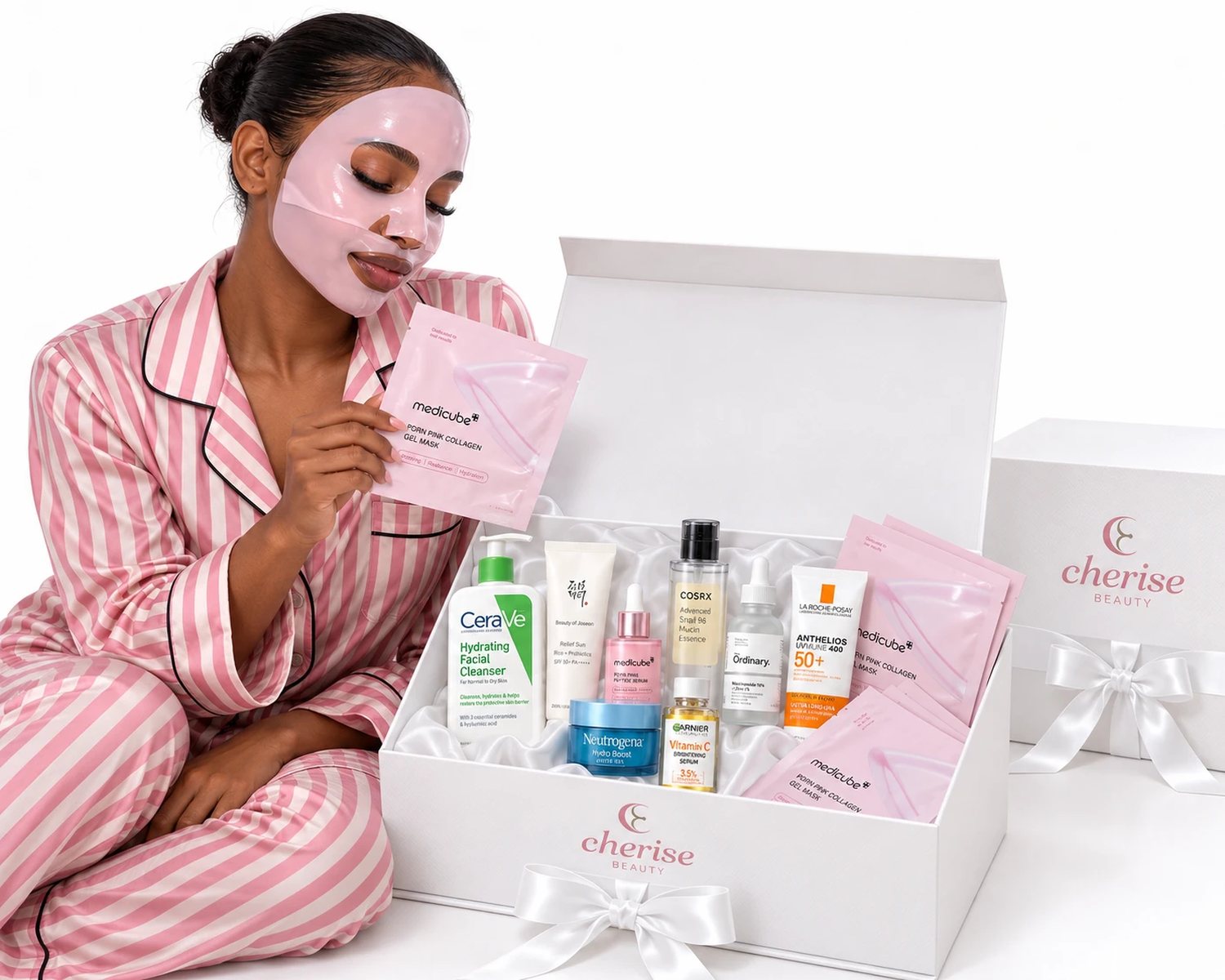 A woman in a sheet mask beside her open Cherise box, the products chosen for her skin inside